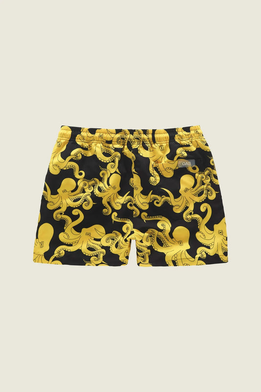 Yellow octopus-patterned swim shorts on a light green background