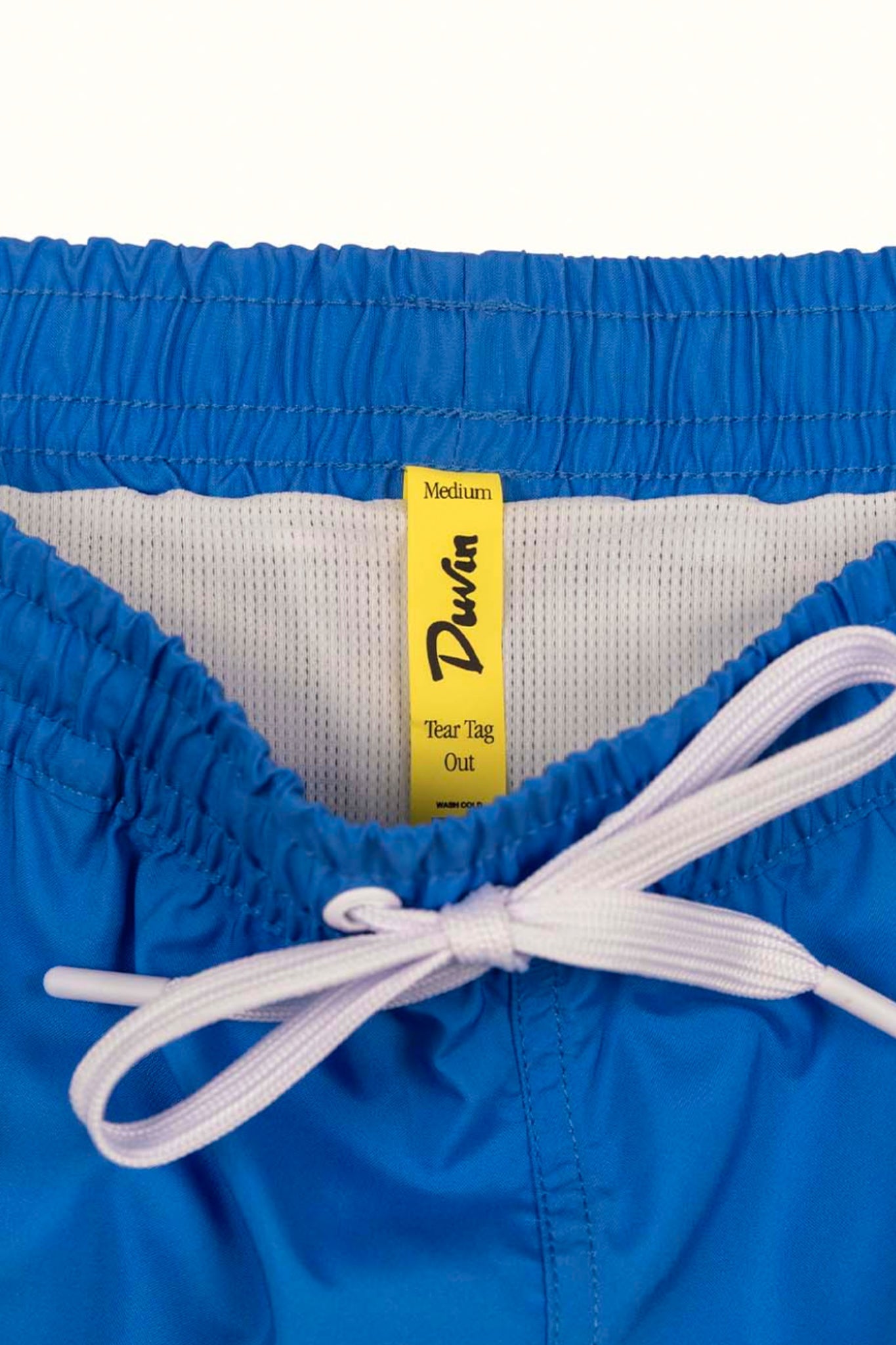 Close-up of blue swim trunks with white drawstring
